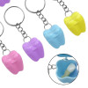 Tooth-shaped keyring container for baby teeth